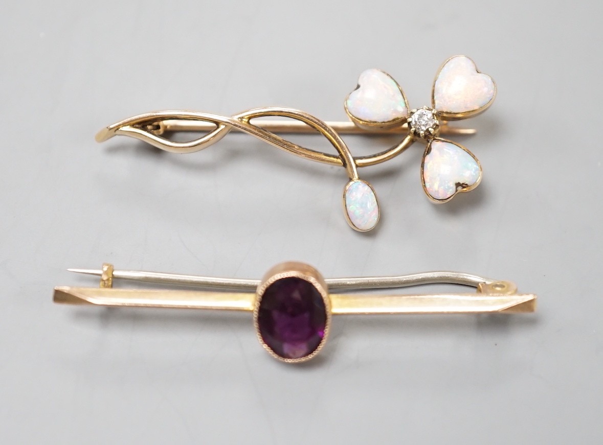 A yellow metal, four stone white opal including heart shape and diamond set foliate brooch, 40mm and a yellow metal and oval cut garnet set bar brooch, gross weight 5.4 grams.